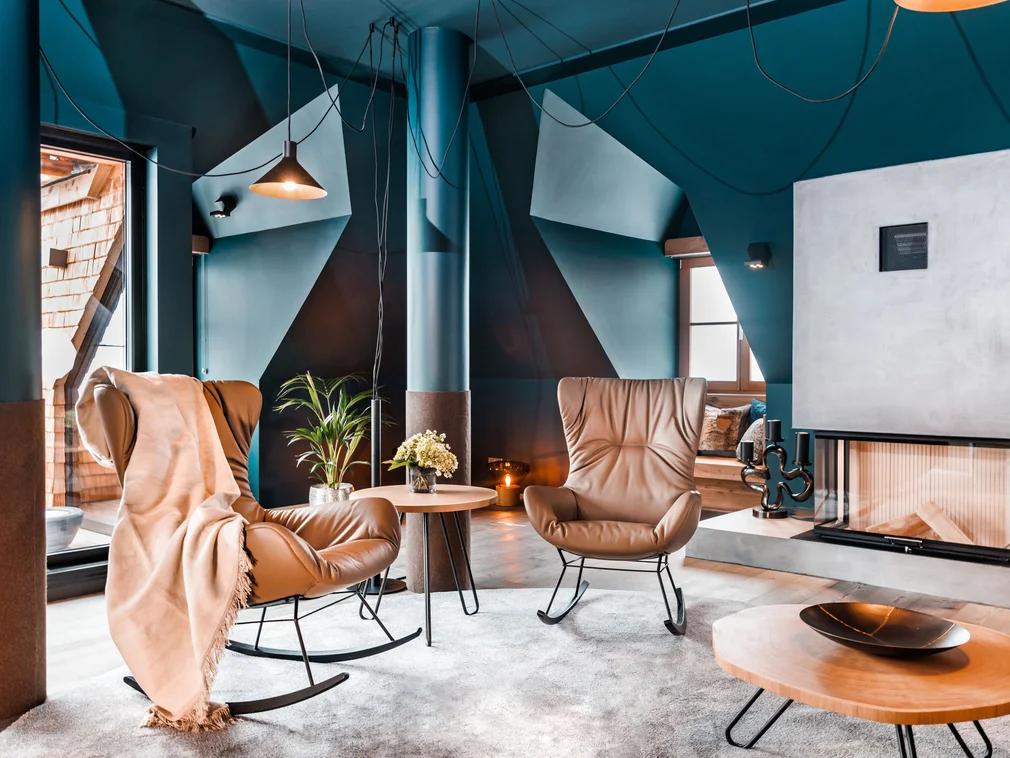 Living room with modern rocking chairs, fireplace and decor