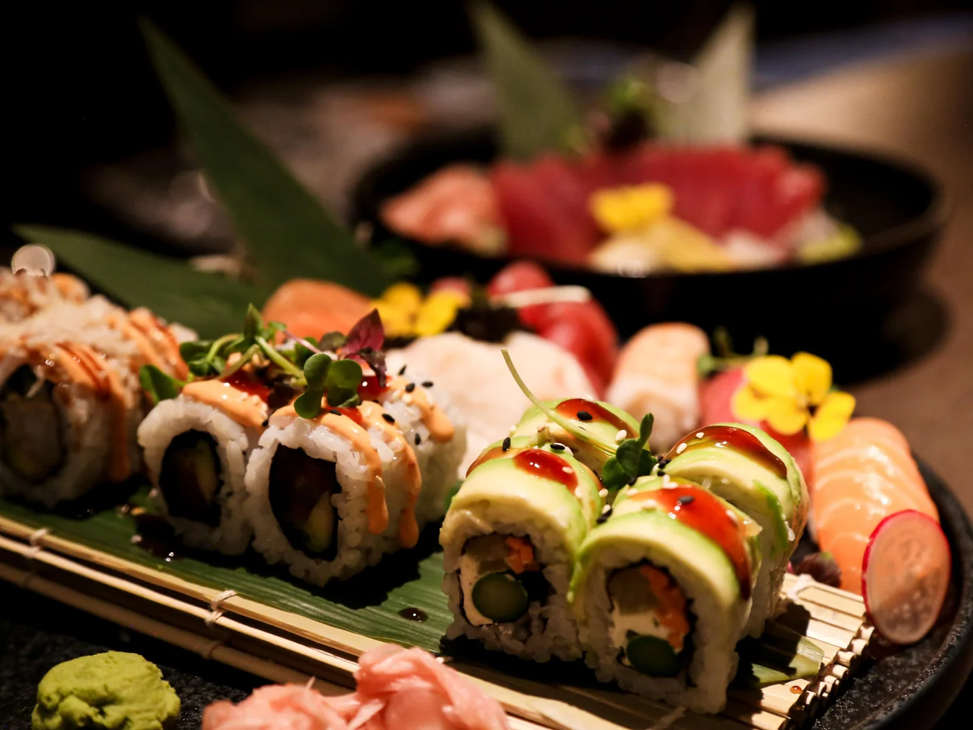 Nahaufnahme von Sushi mit Wasabi und Ingwer auf einem Bambusmatte