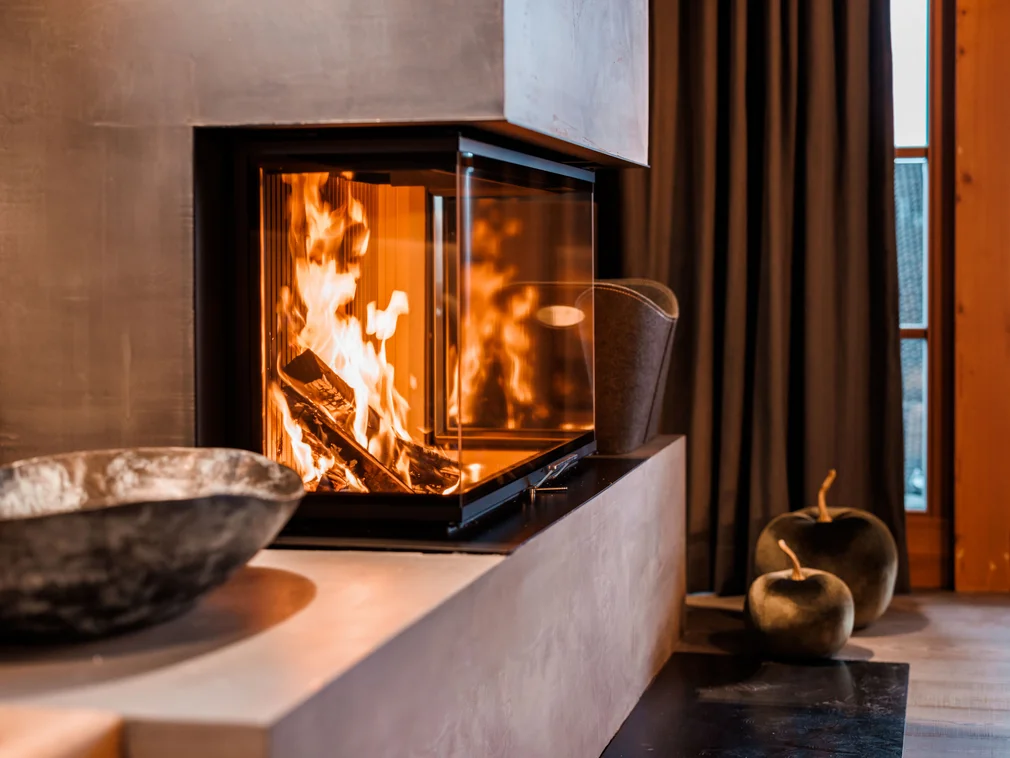 Modern fireplace with burning fire in cozy living room